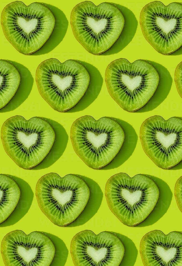 Kiwi fruit in the form of hearts on a green background - Fruit, kiwi