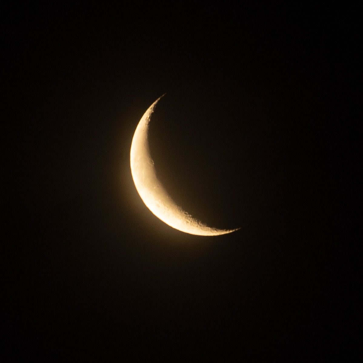 A waxing crescent moon in the night sky. - Moon
