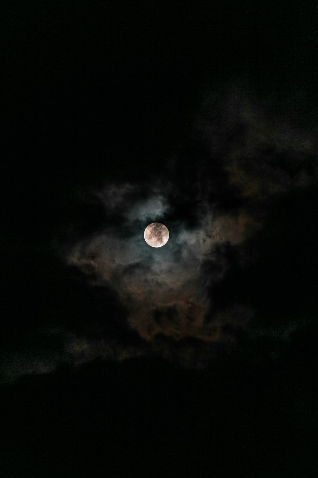 IPhone wallpaper of a full moon with clouds in the night sky. - Moon