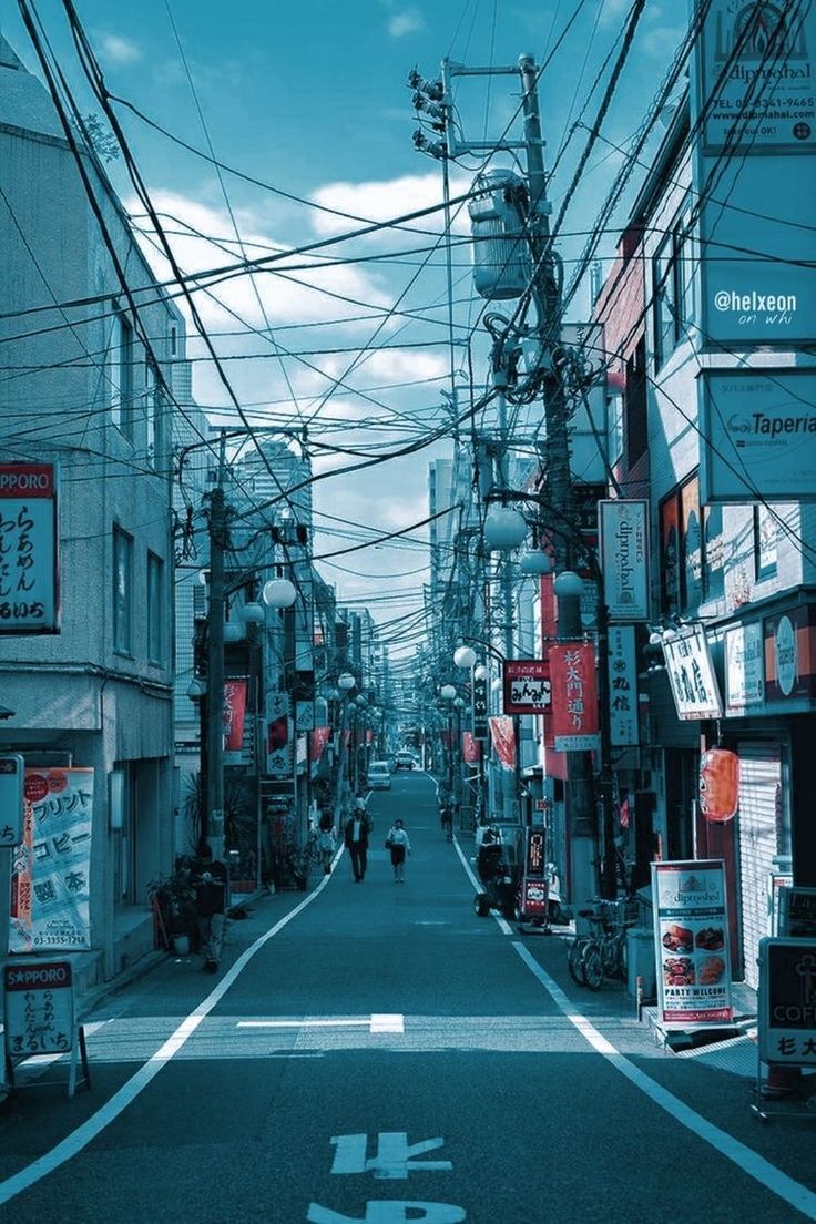A street with wires and buildings in the background - Japan
