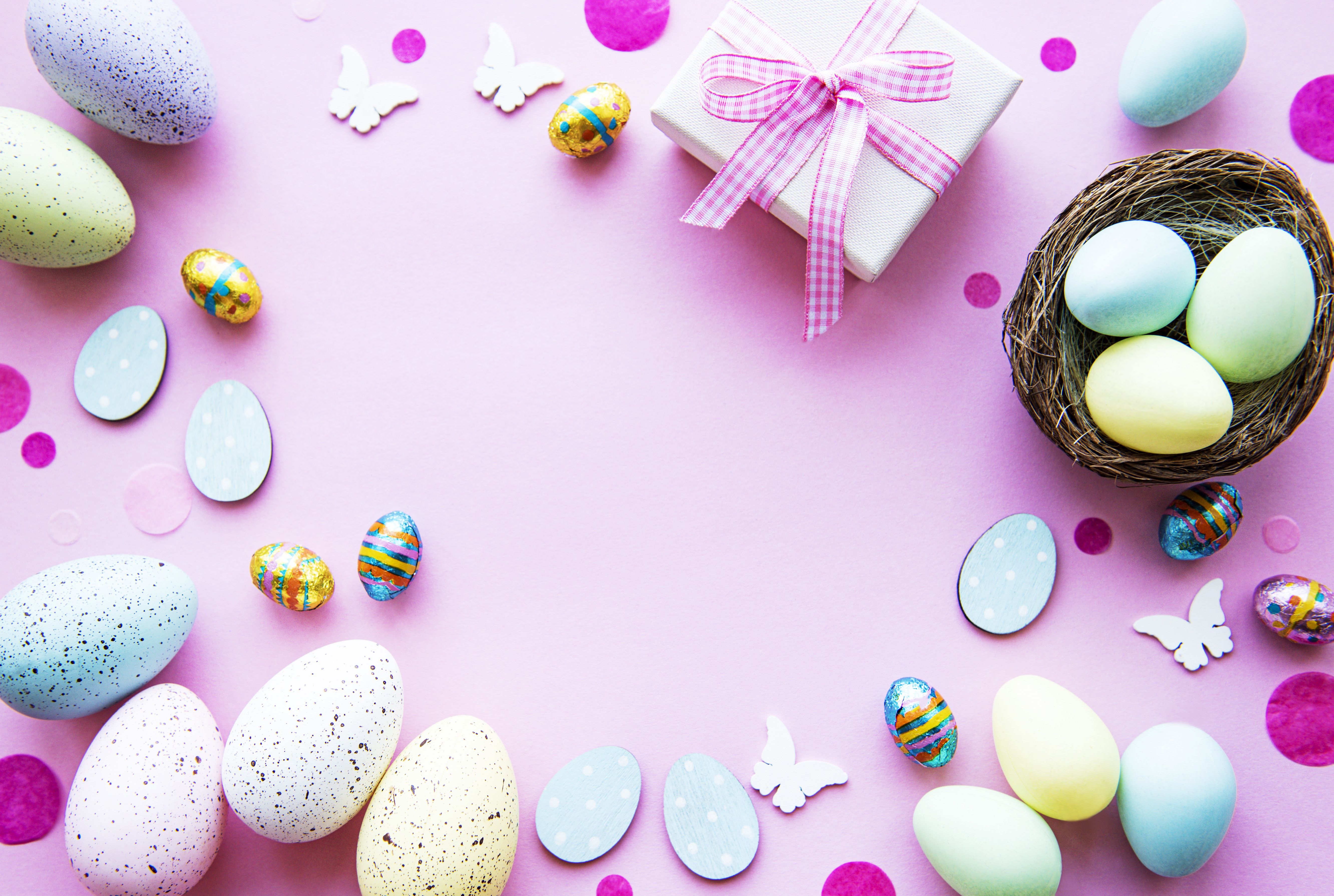 Easter eggs and a gift box on a pink background - Easter