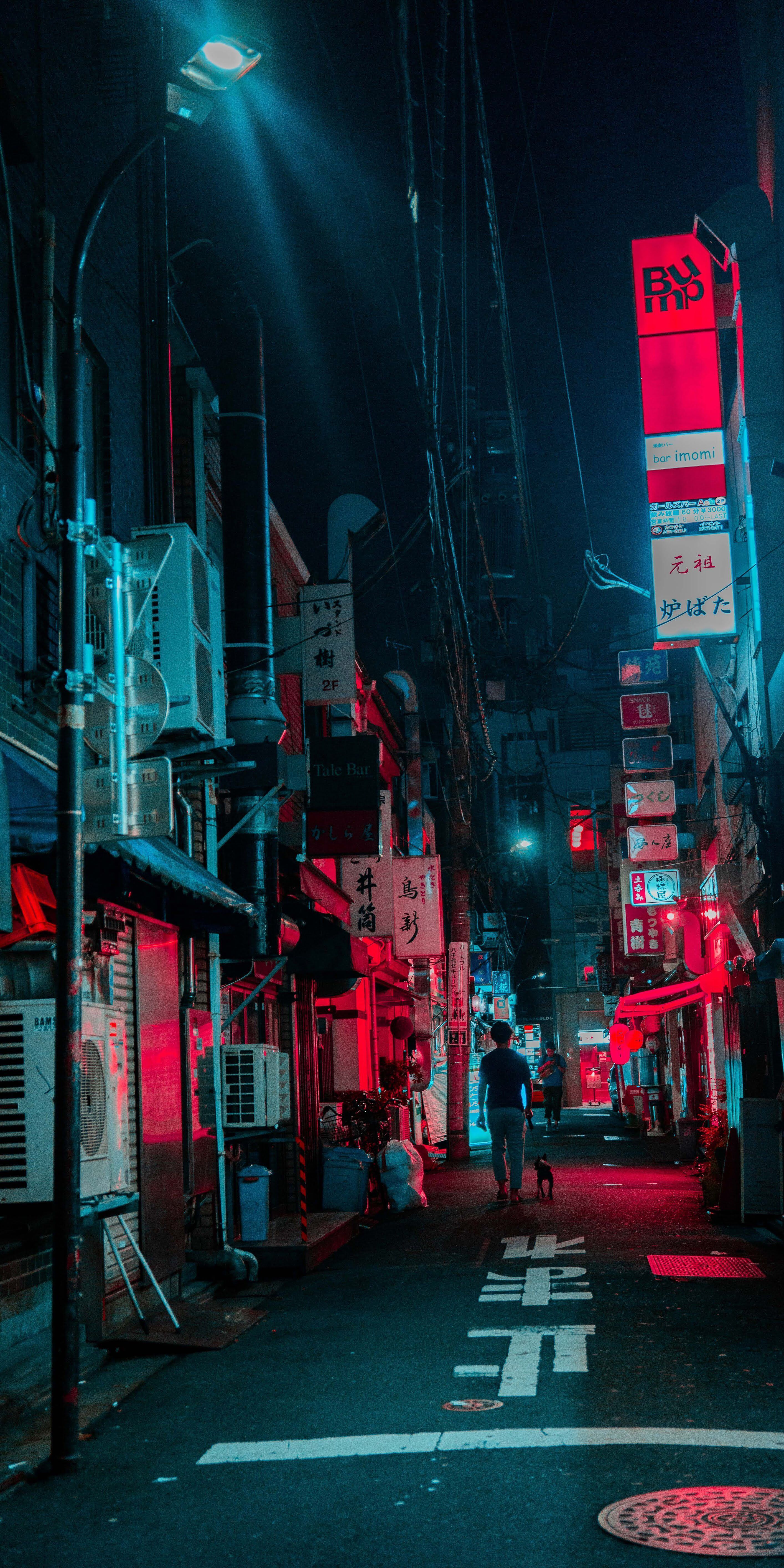 A person walking down a dark alley with red lights - Cyberpunk