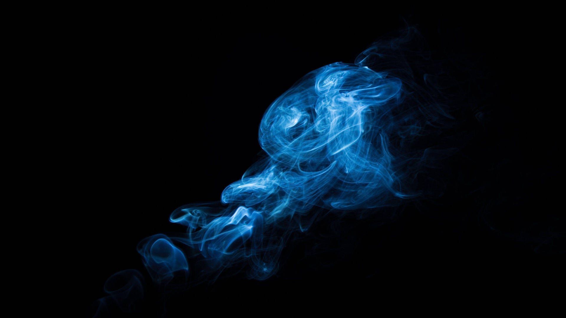 A blue smoke is blowing in the air - Smoke