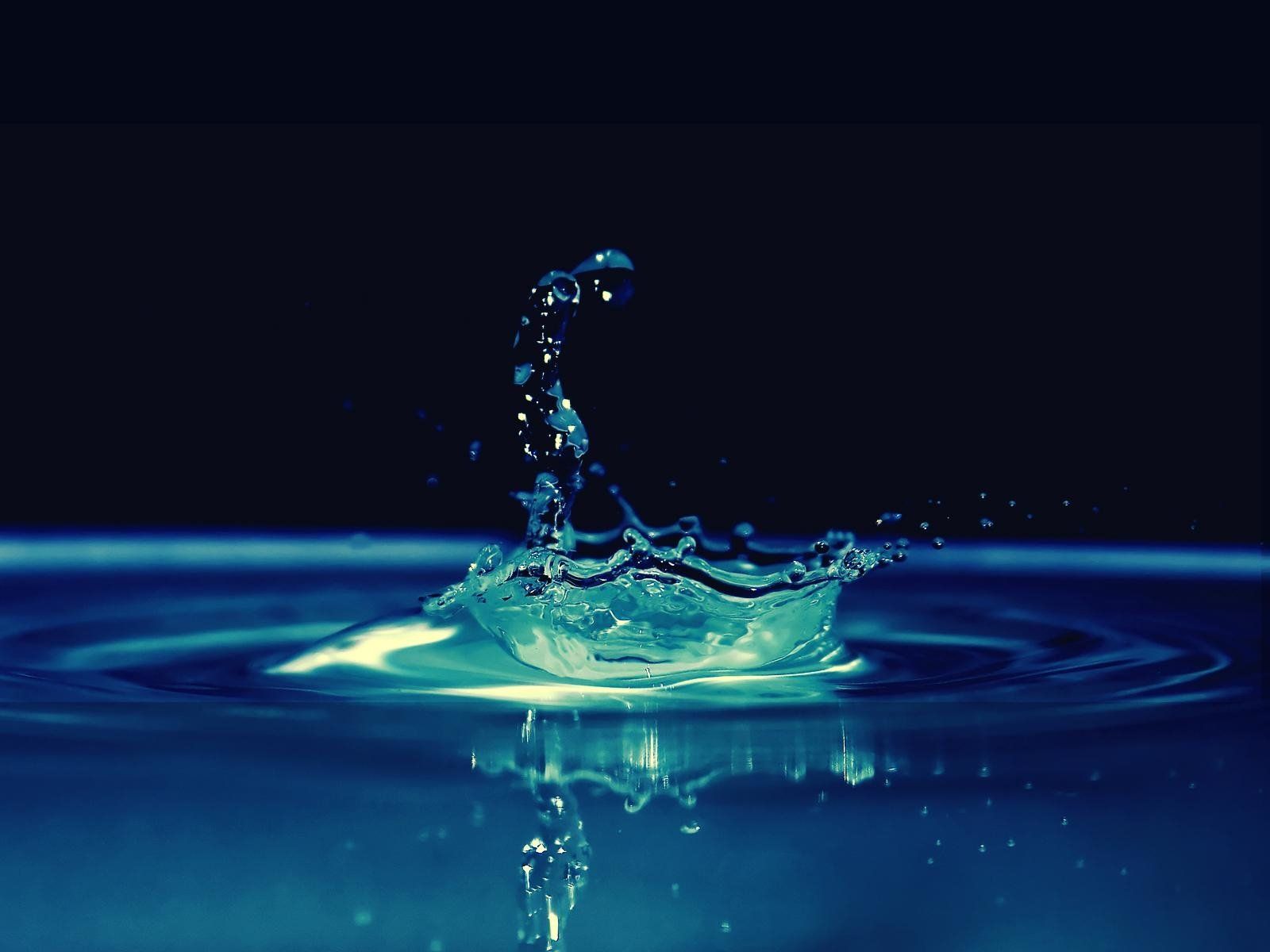 A water droplet is splashing into the surface - Water