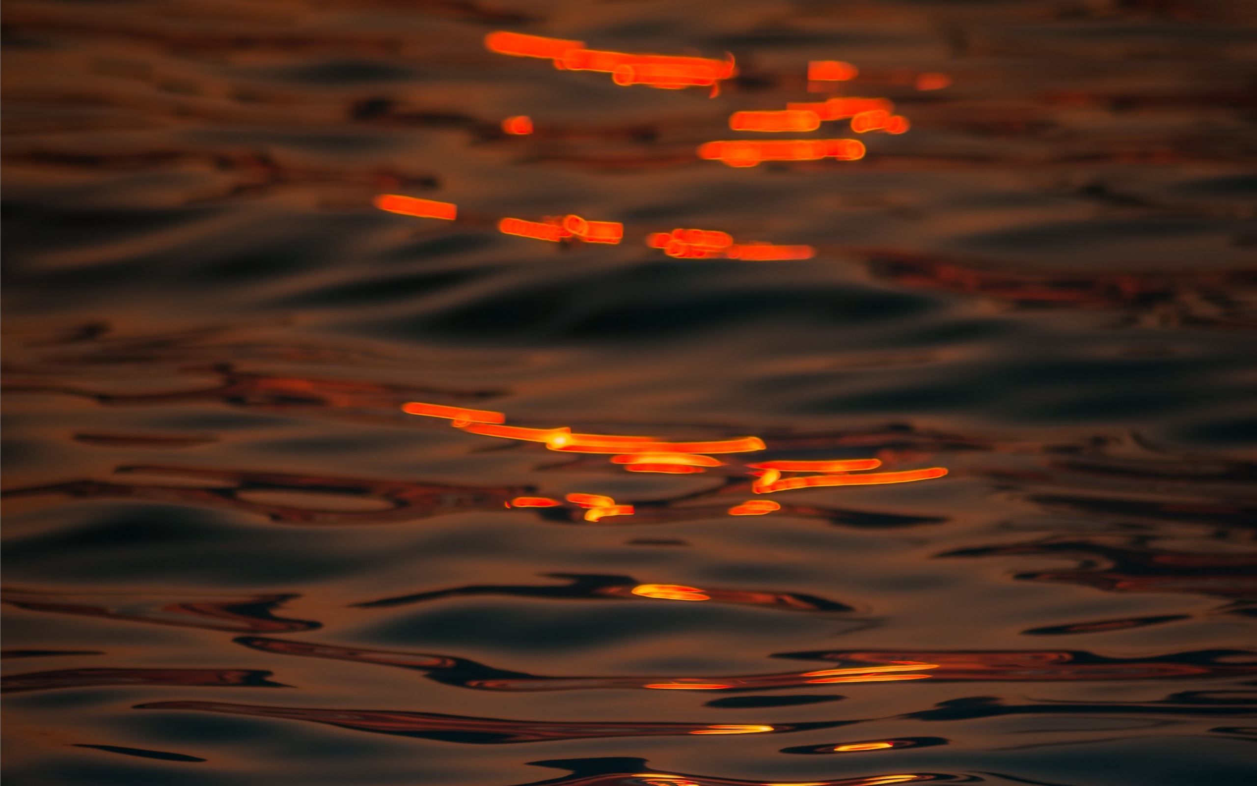 A close up of water with orange light - Water