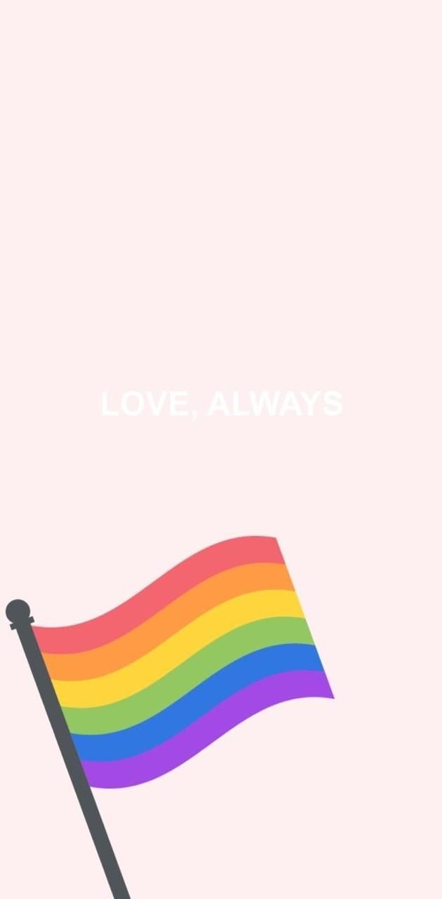 A rainbow flag waving in the wind with the words 