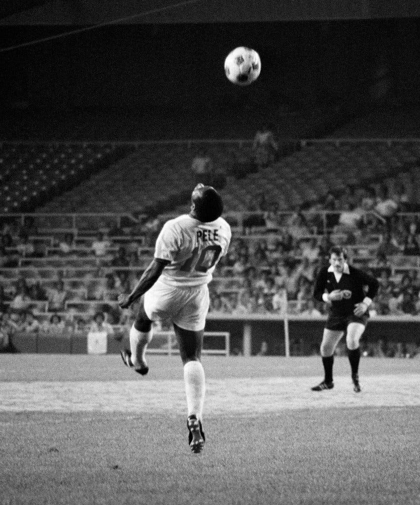 Pelé heading the ball during a match - Soccer
