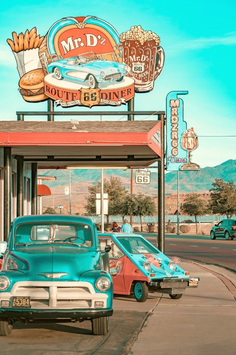 A blue car parked in front of an old diner - 50s