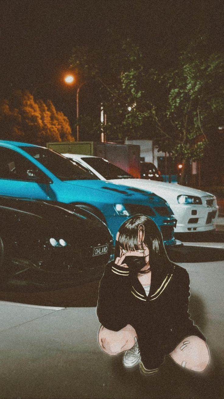 A girl in a sailor suit kneeling down in front of a car. - JDM