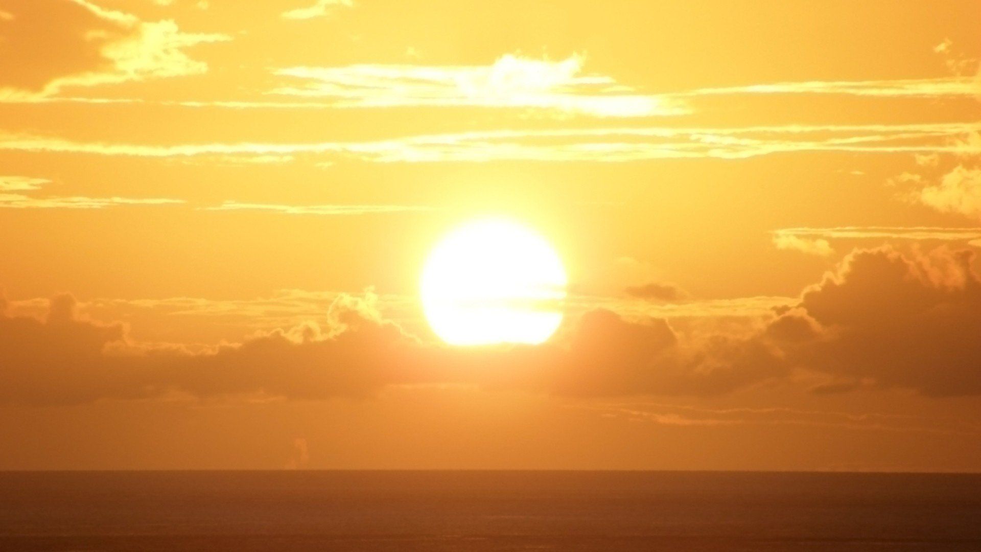 The sun setting over the ocean - Sun