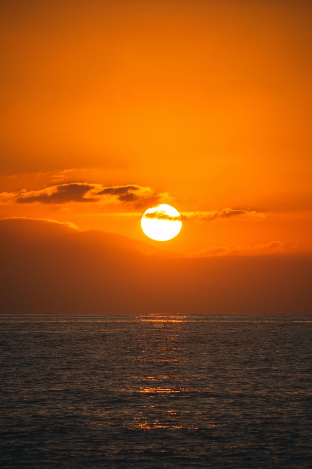 sun setting over the horizon photo