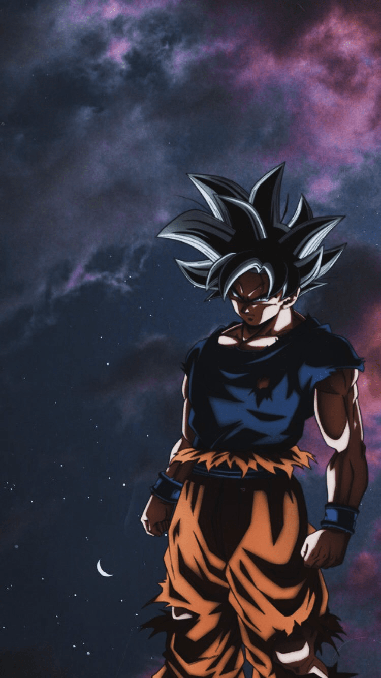 A man in orange and black standing on the ground - Goku