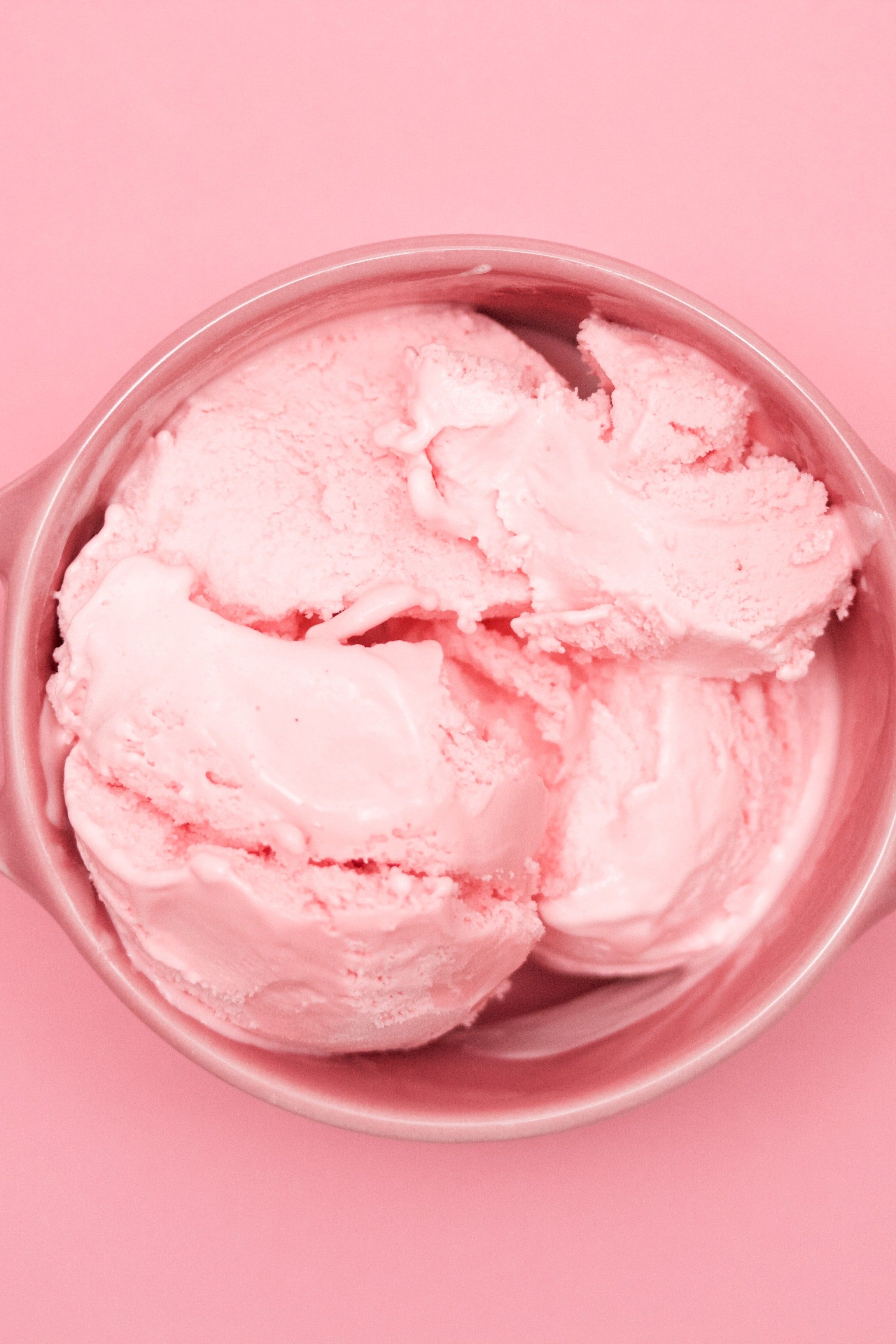 A pink bowl of strawberry ice cream on a pink background - Ice cream