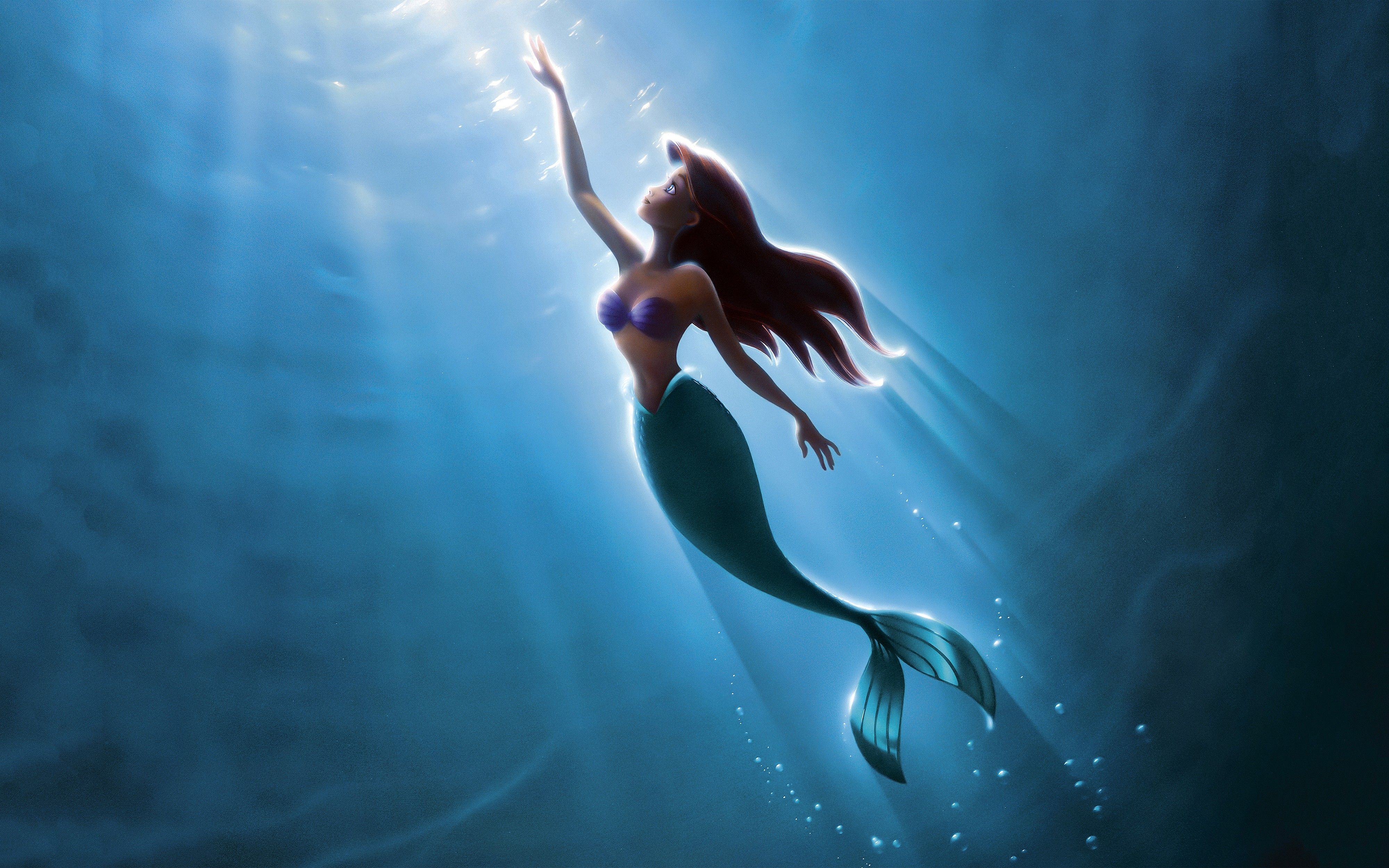 The little mermaid is swimming in a blue ocean - Ariel, mermaid