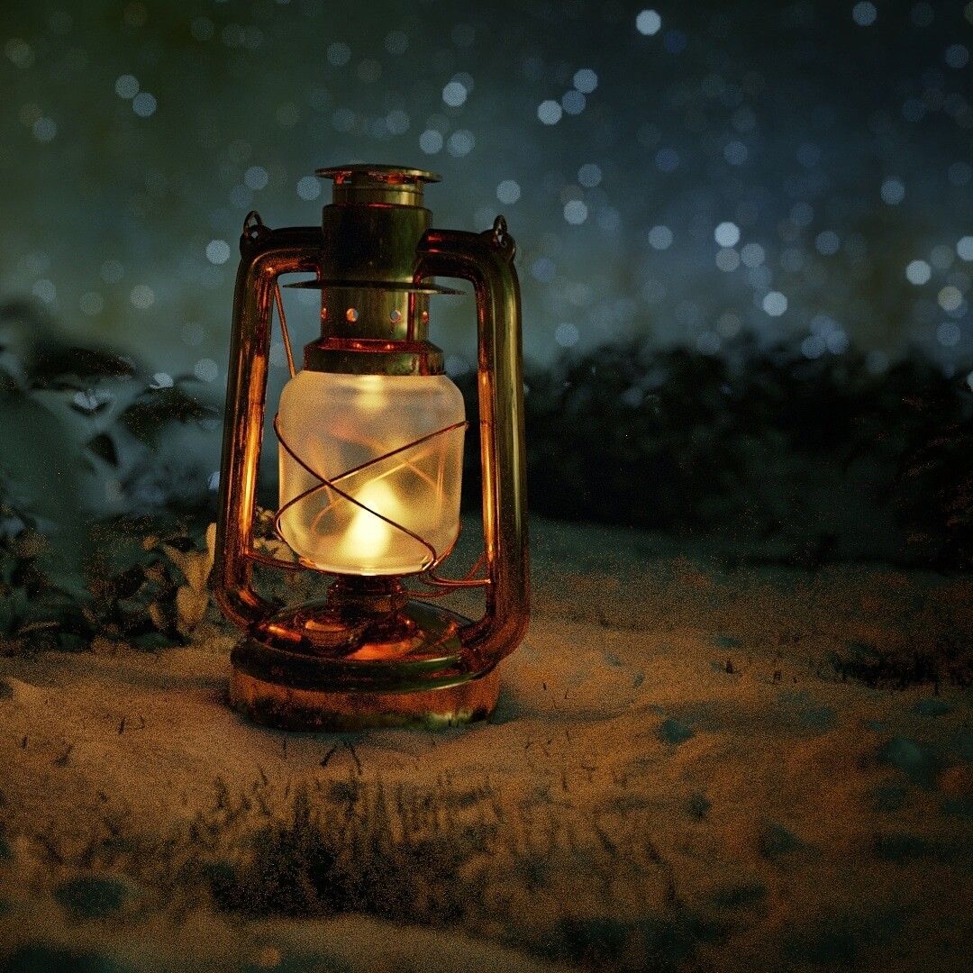 A lantern sitting on the ground in front of trees - Camping
