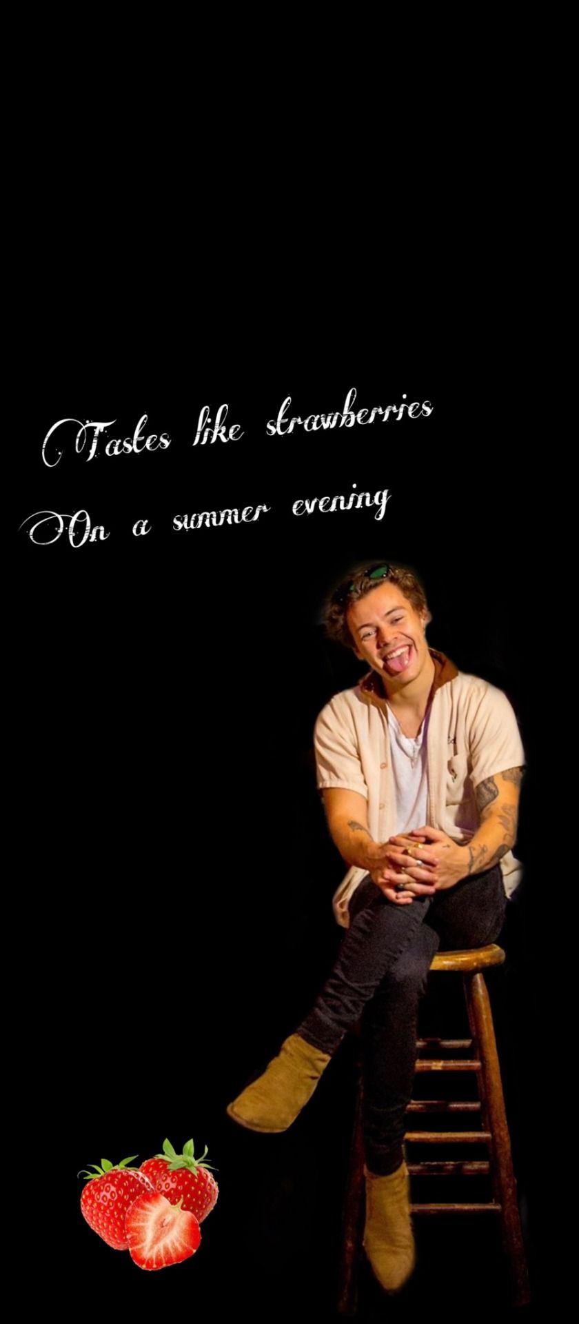 A man sitting on top of some strawberries - Harry Styles