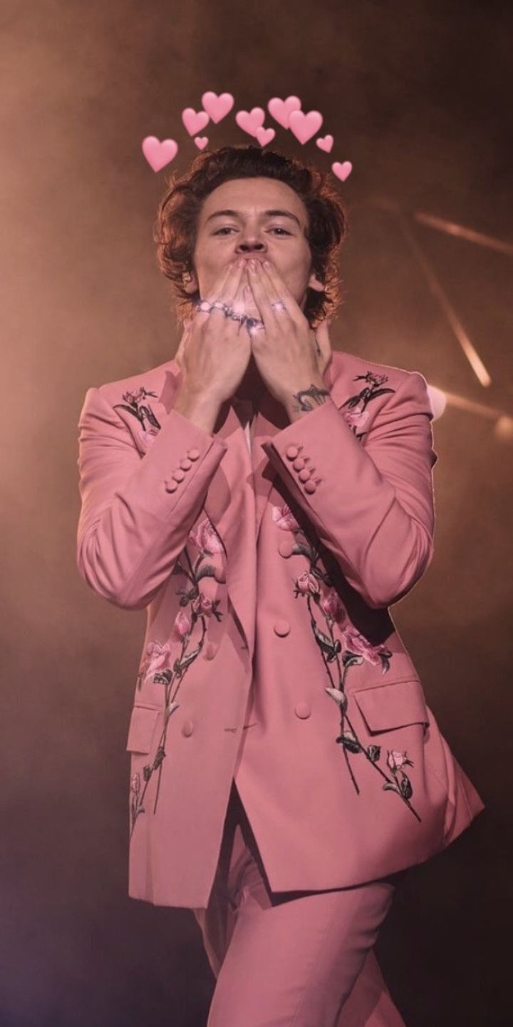 Harry Styles wearing a pink suit with hearts above his head - Harry Styles