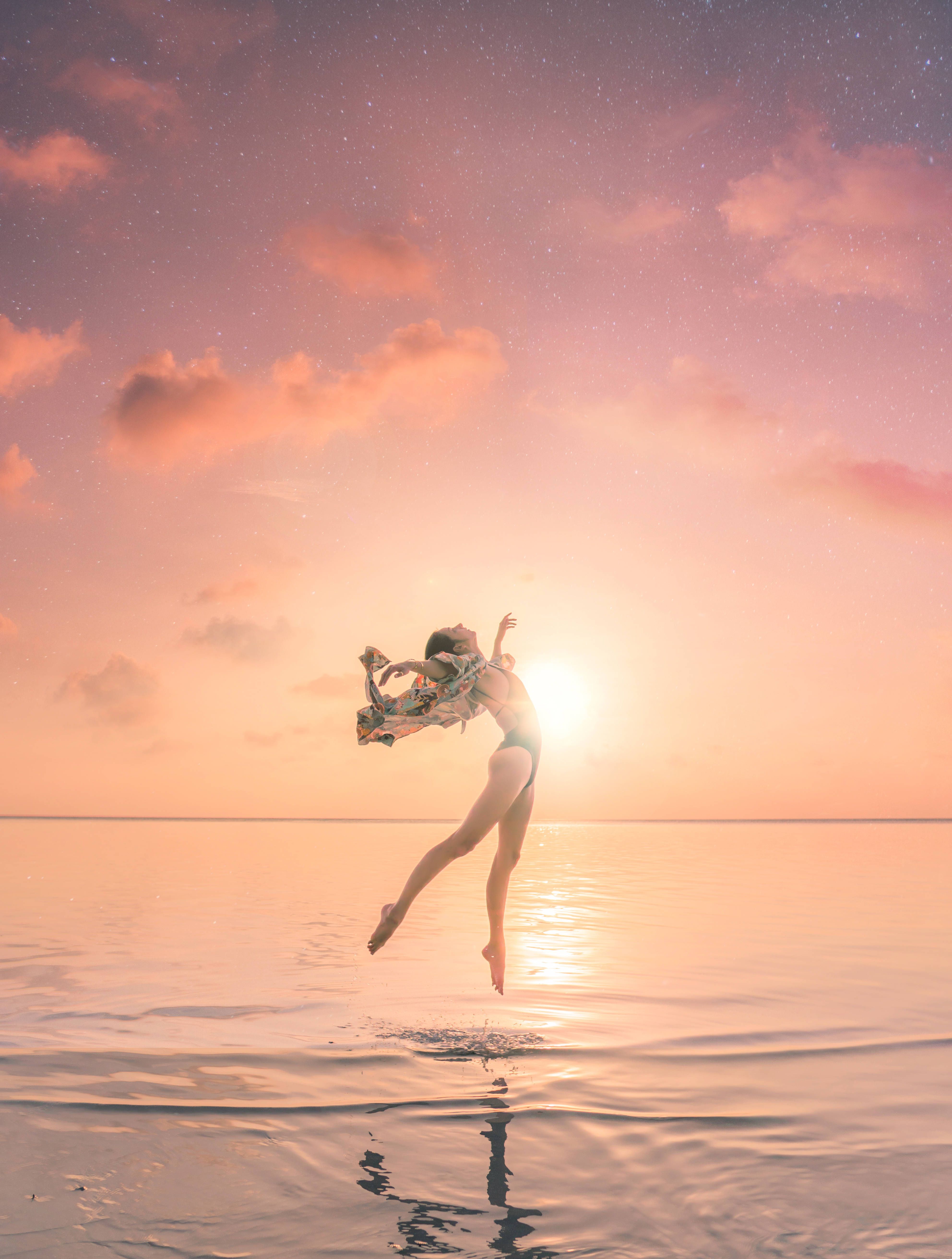 Download Gymnastics Dance In Ocean Sunset Wallpaper