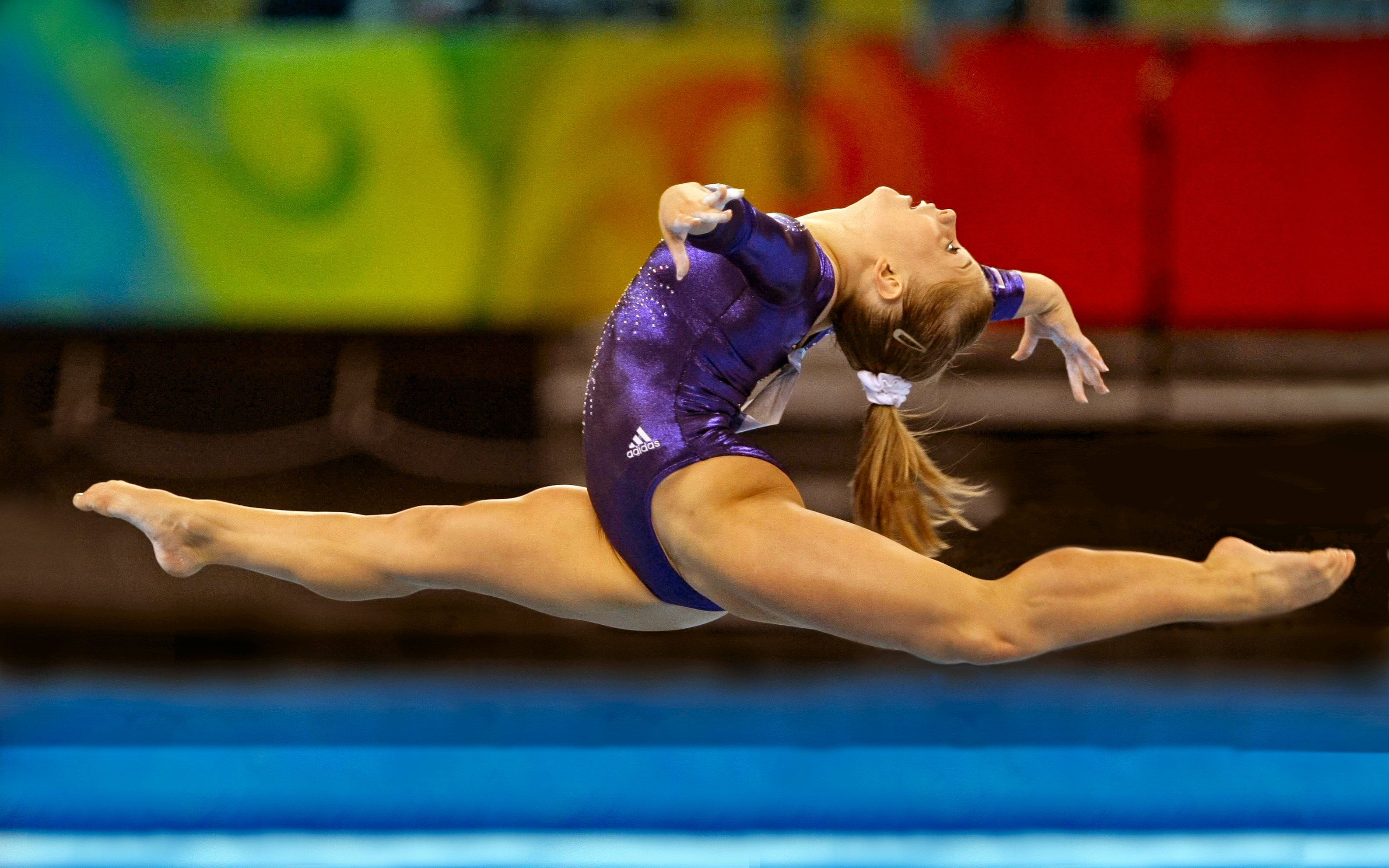 A woman performing on the balance beam - Gymnastics