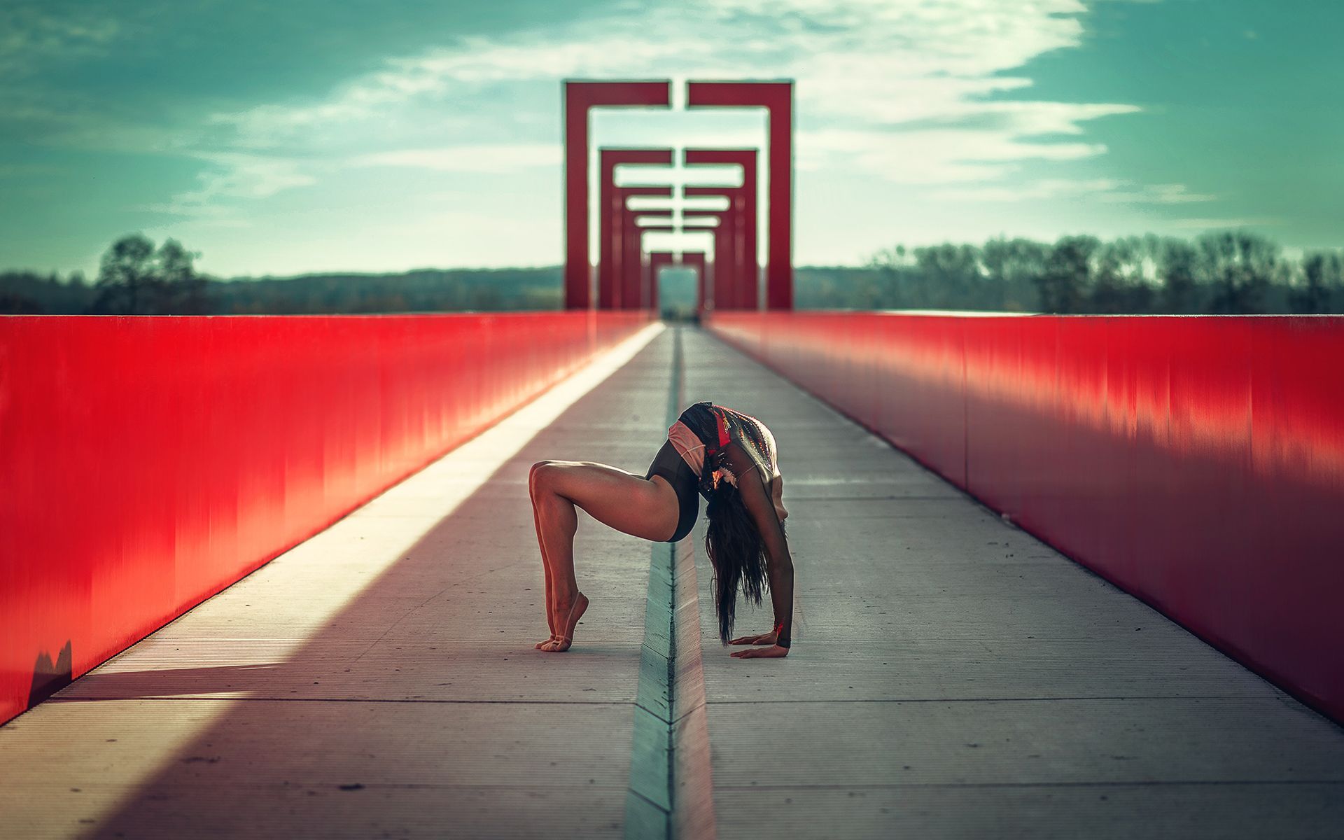 A woman doing yoga on a bridge - Gymnastics