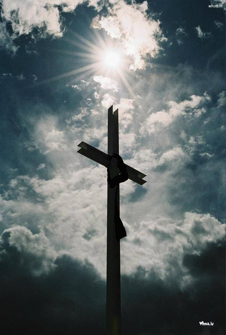 The cross with the sun behind it. - Cross