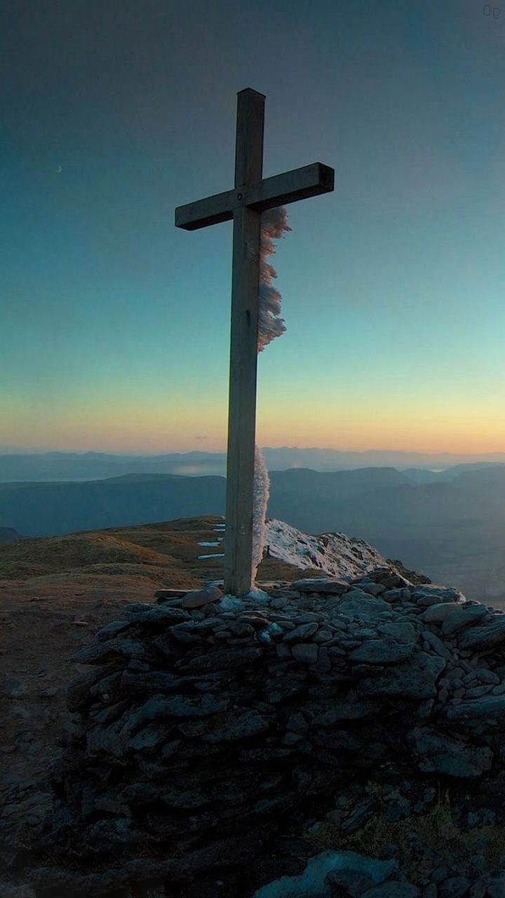 A cross on top of a mountain. - Cross