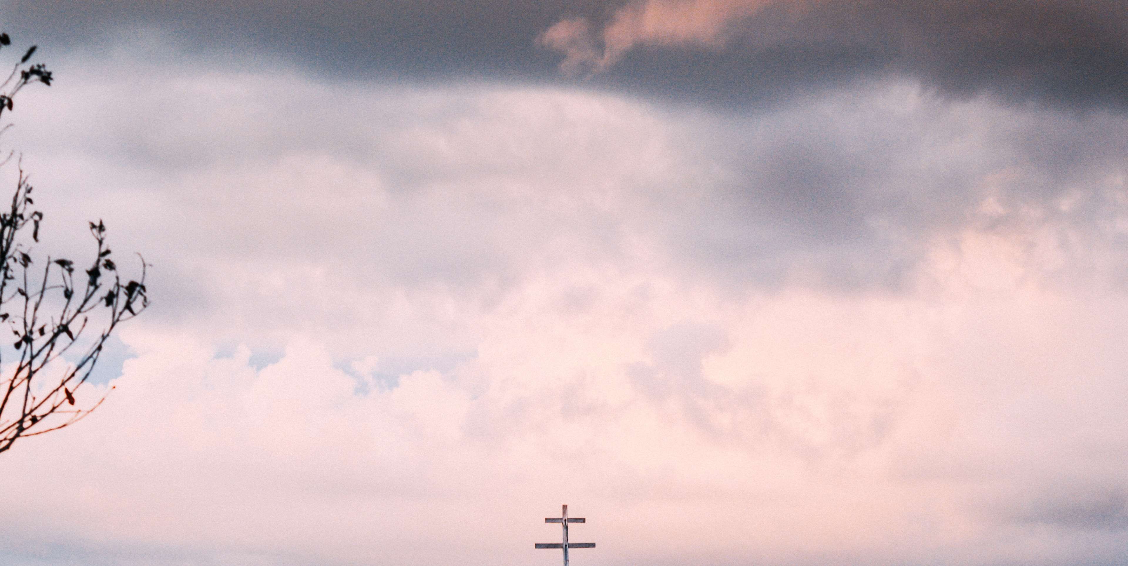 A cross against a cloudy sky - Cross