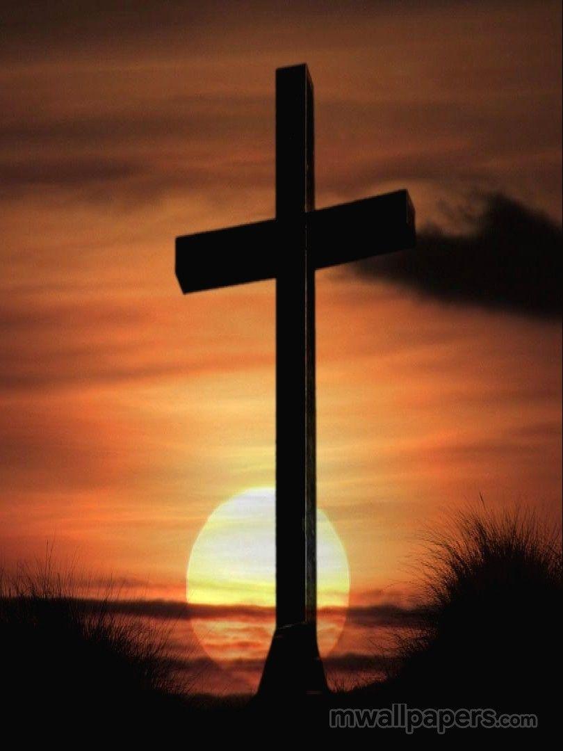 The cross with the sun behind it. - Cross