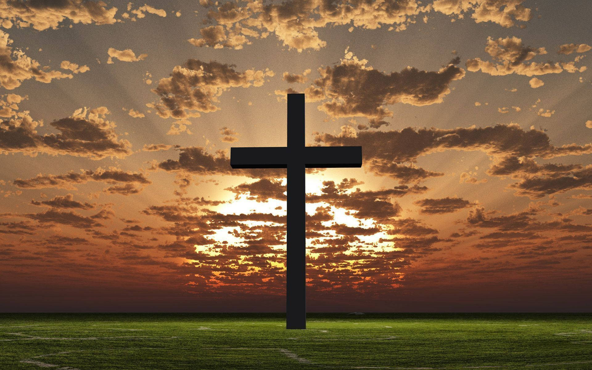 A cross on a grassy hill with the sun setting behind it. - Cross