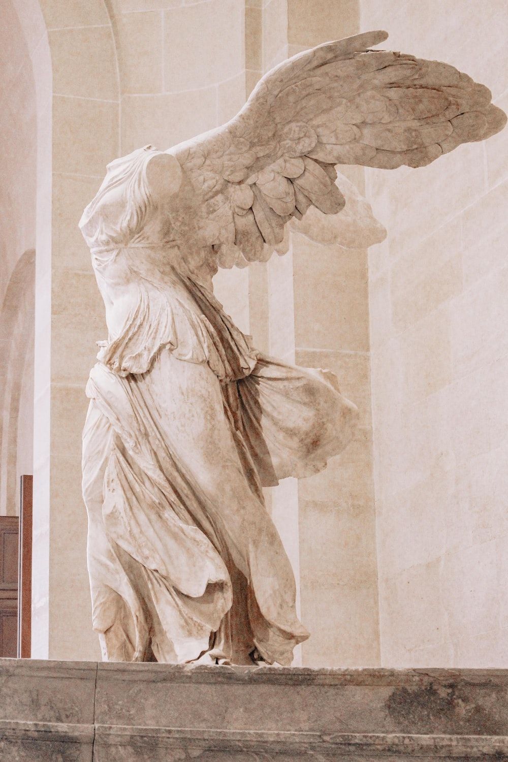 A statue of an angel with wings spread - Greek statue
