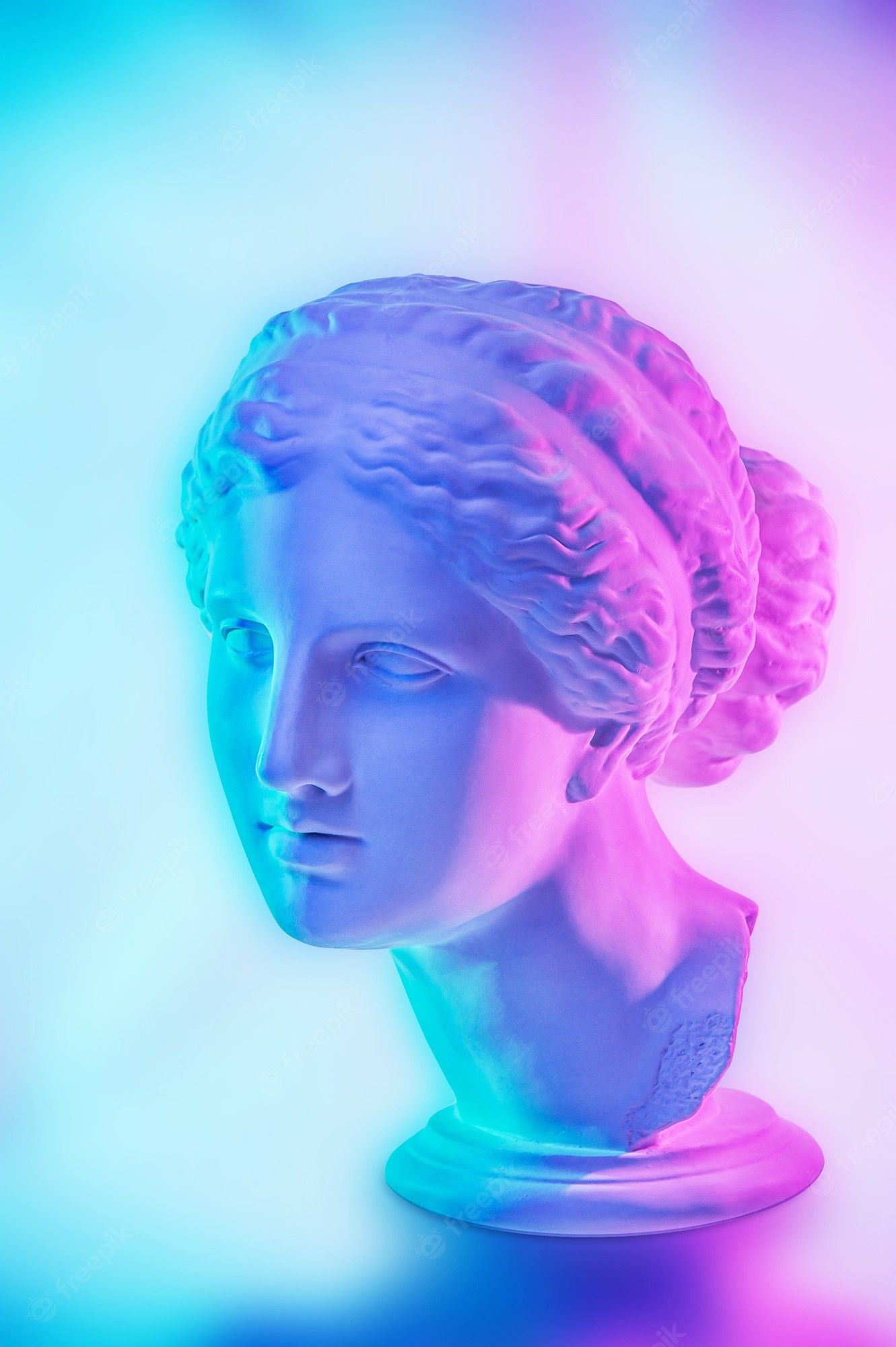 A sculpture of a woman's head in blue and purple light - Greek statue