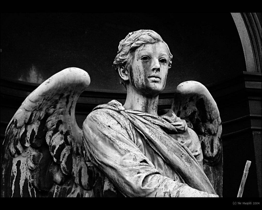 A black and white statue of an angel - Greek statue