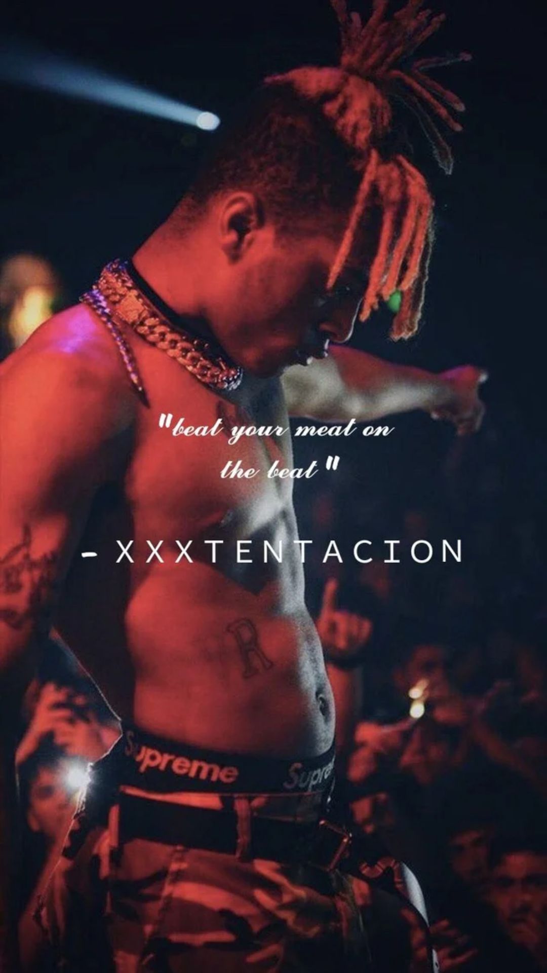 A man with dreads and tattoos on his chest - XXXTentacion