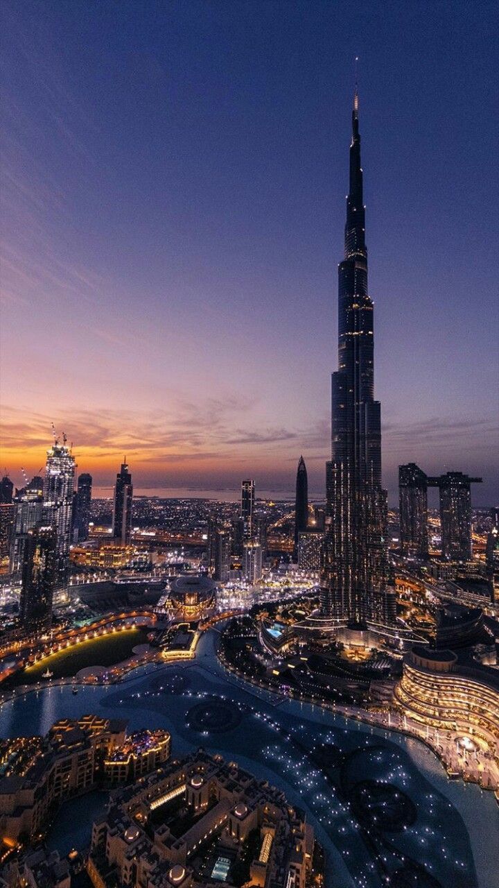 The Burj Khalifa, the tallest building in the world, towering over the city of Dubai at night. - Dubai, city, beautiful