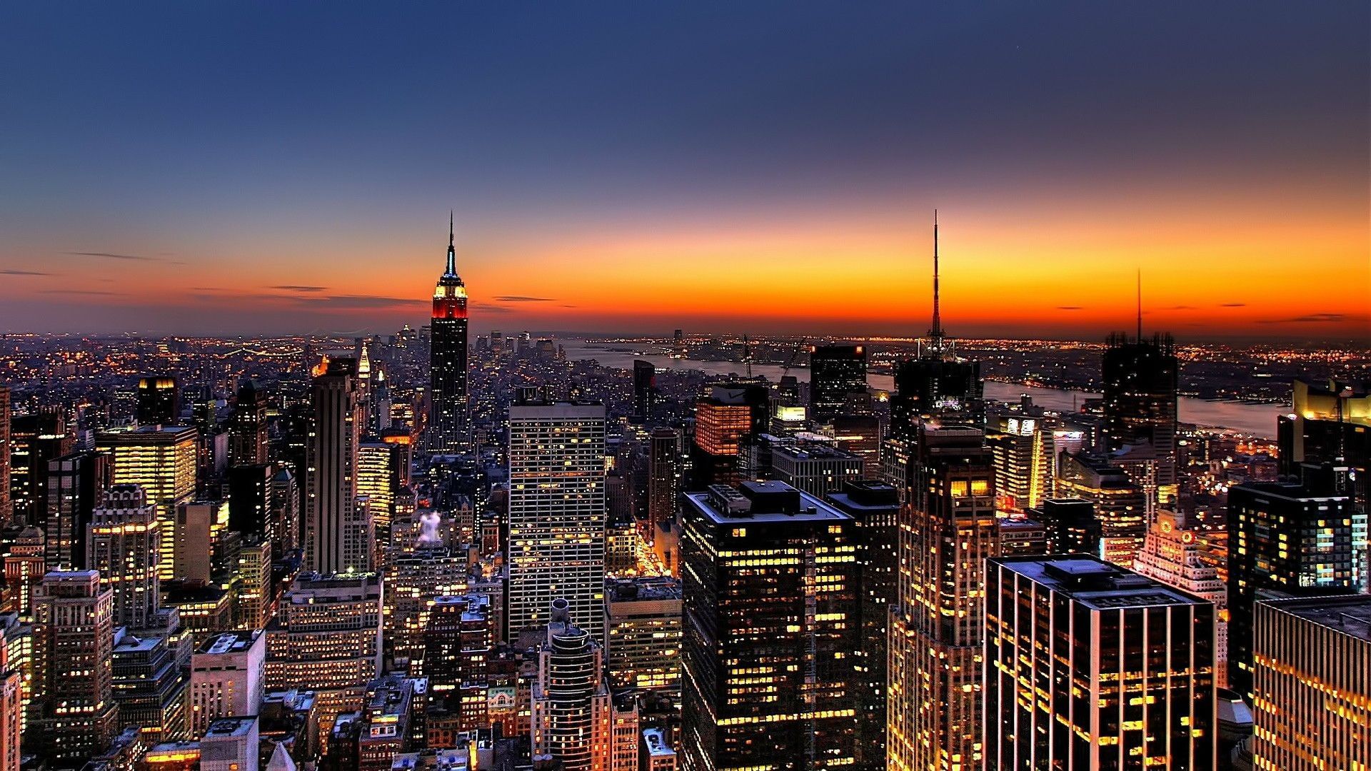 A city skyline at night with the sun setting - City, sunset, New York