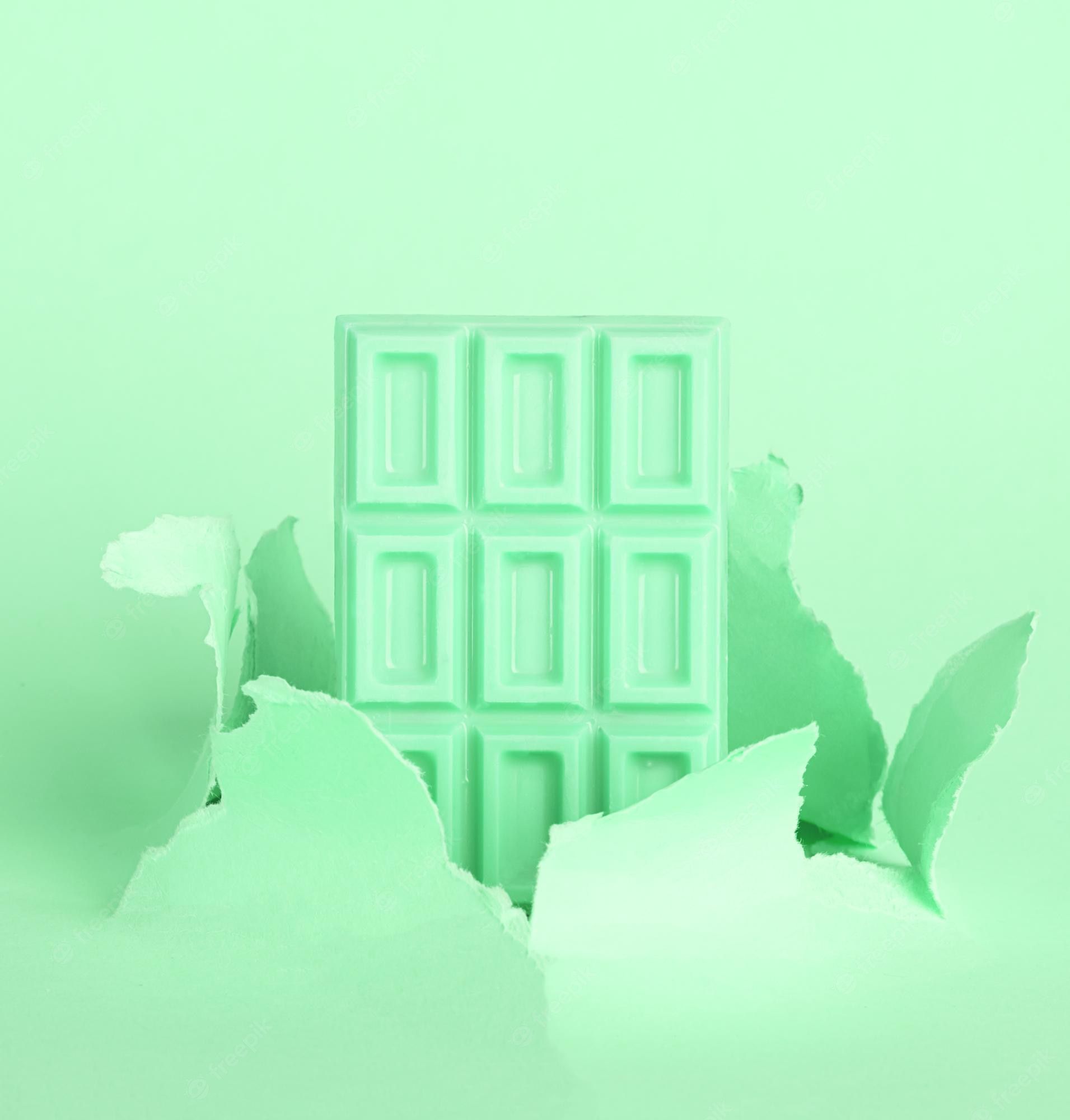 A mint green chocolate bar with a green background - Mint green