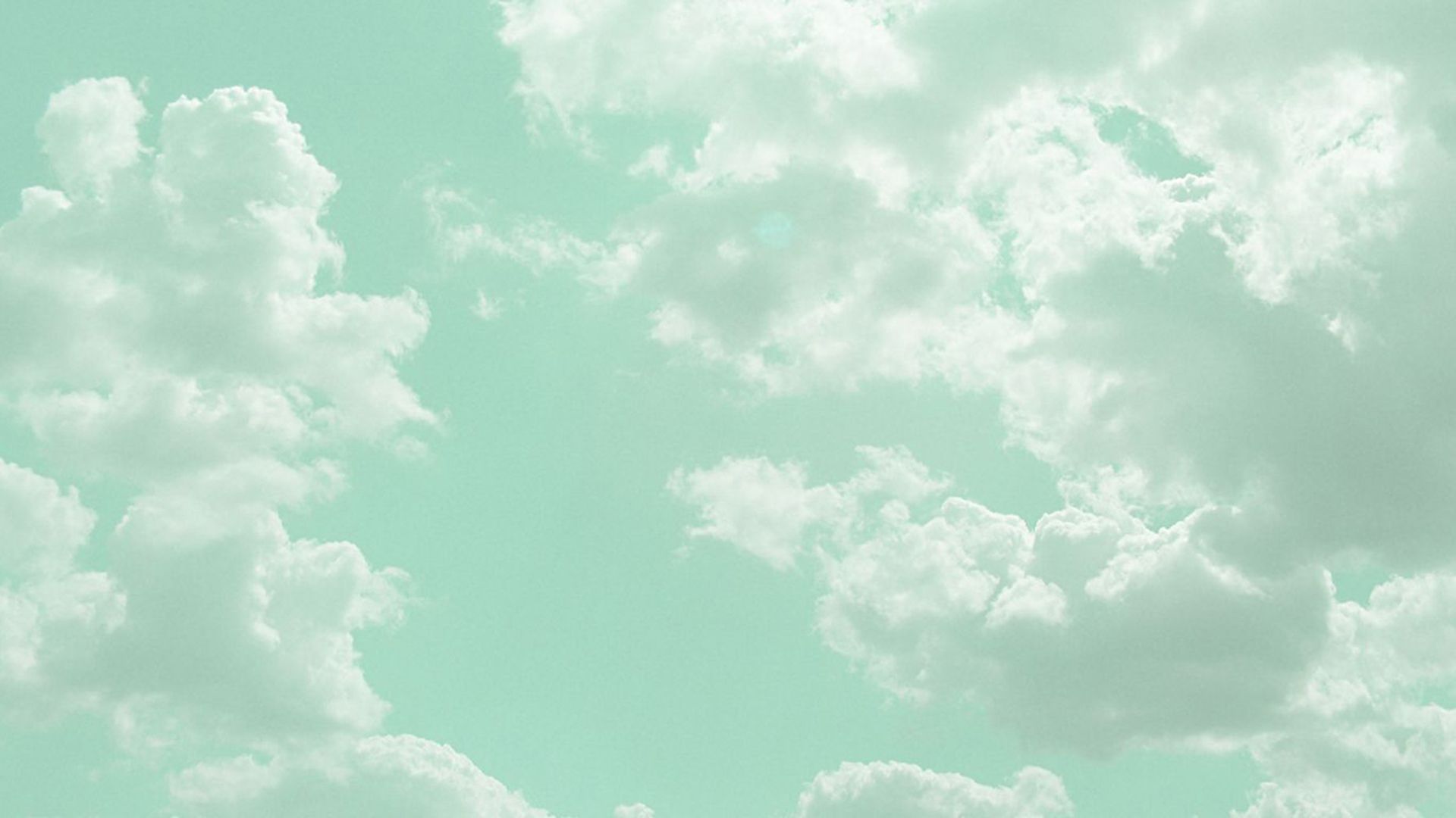 A plane flying in the sky with clouds - Mint green, pastel green