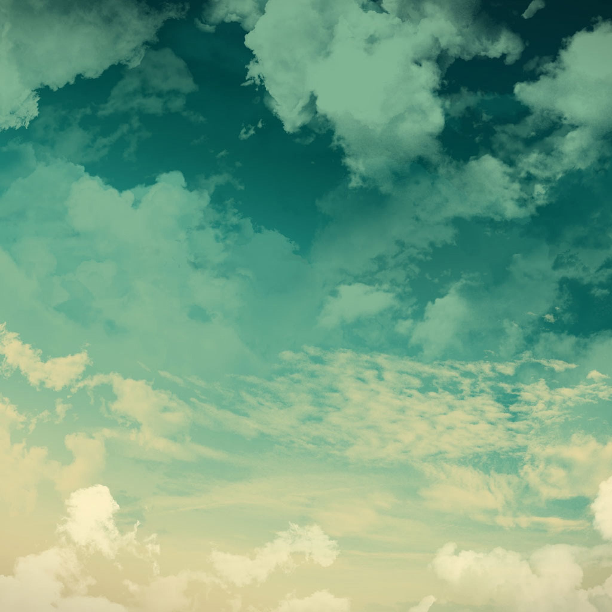 A blue and green gradient image of a cloudy sky - Mint green