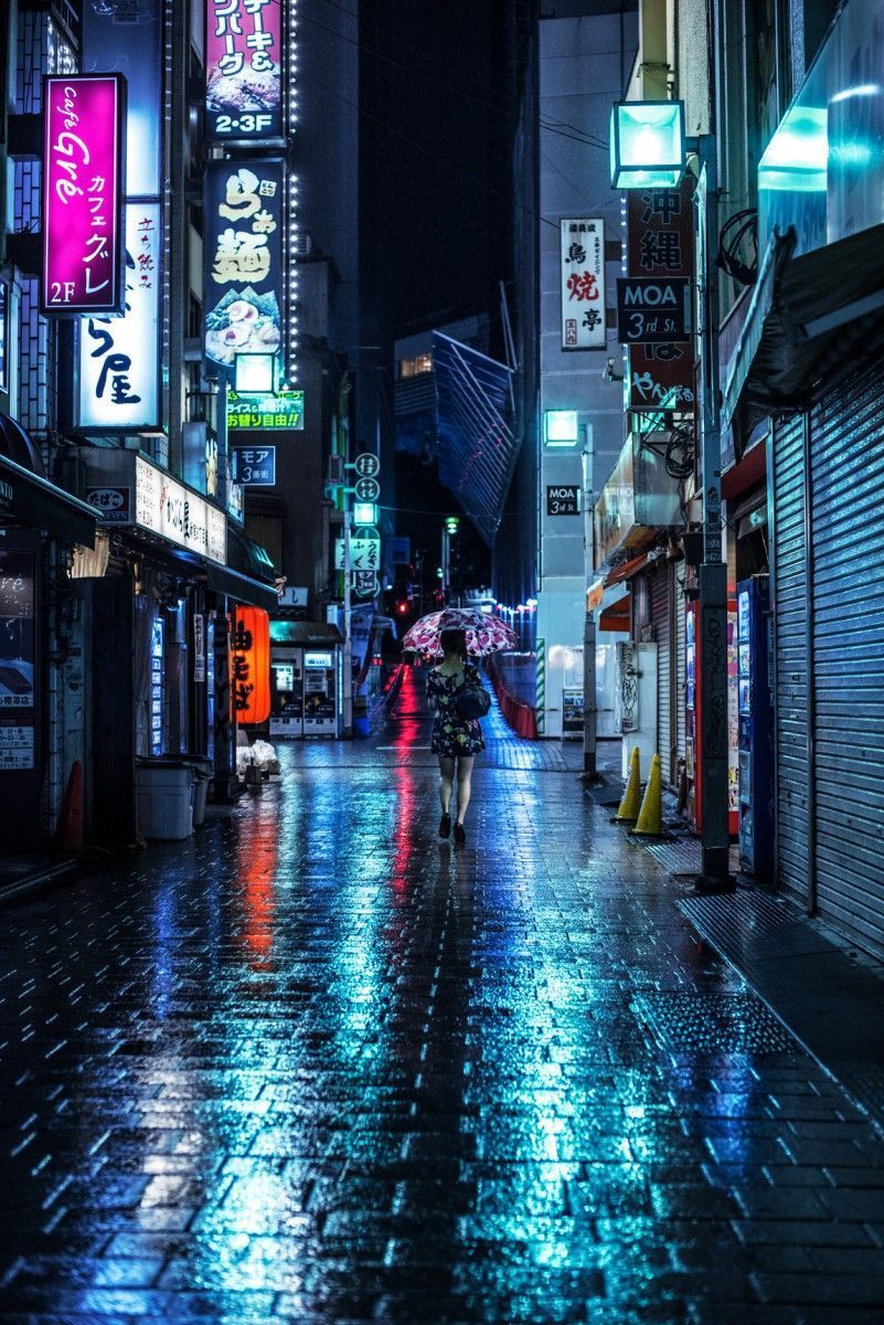 A person walking down the street with an umbrella - Tokyo