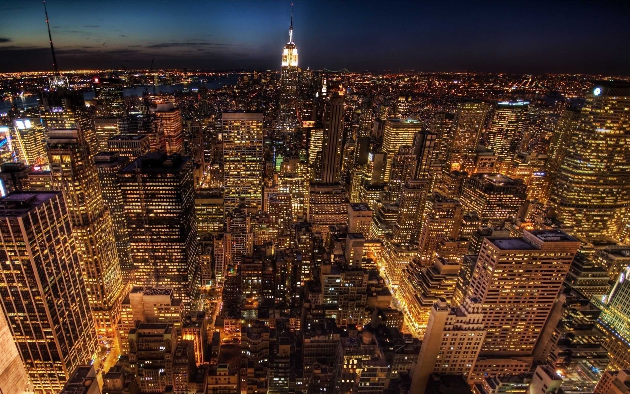A city skyline at night with buildings and lights - New York, 2560x1600