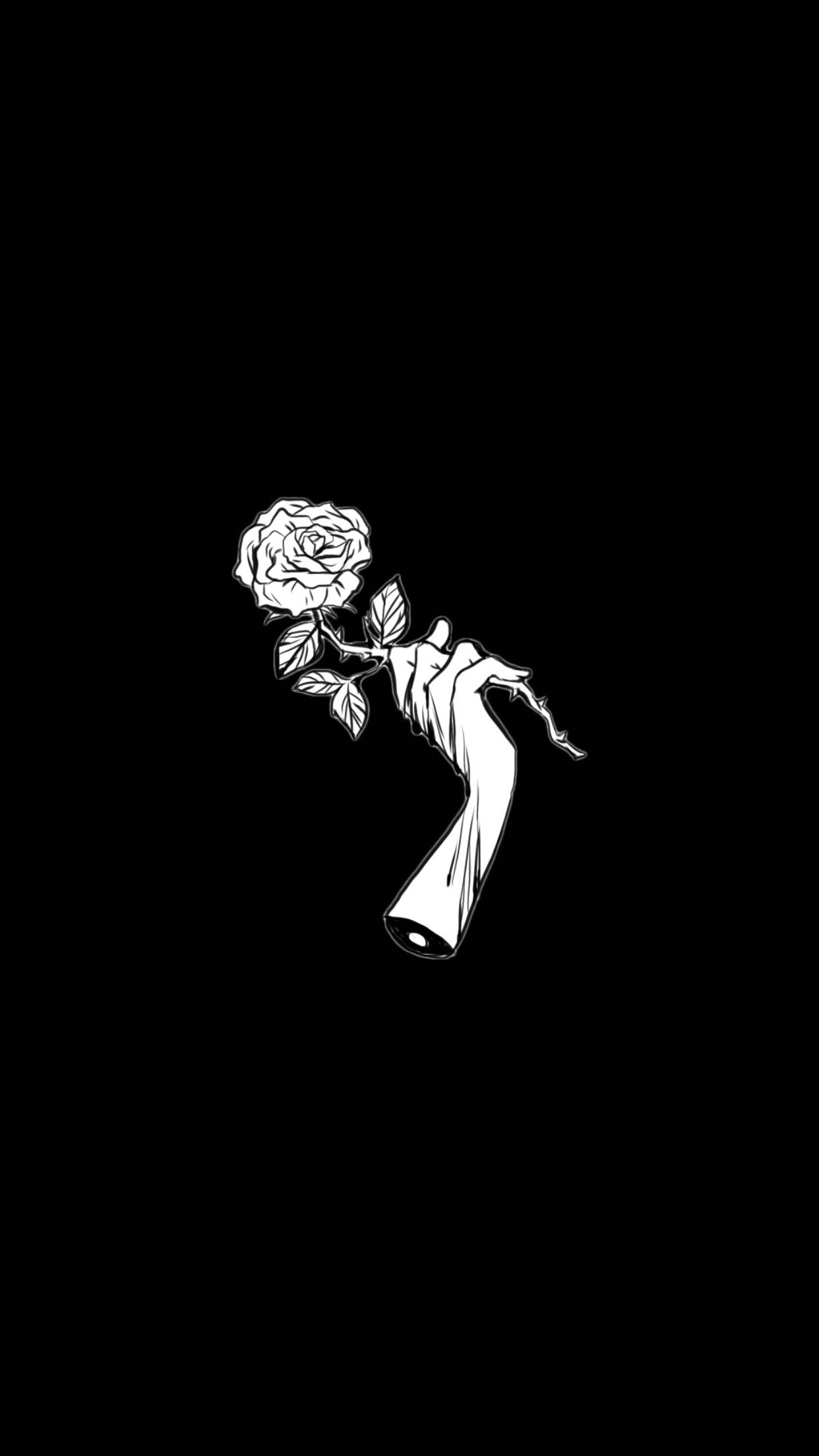 A black and white image of an arm holding flowers - Gothic
