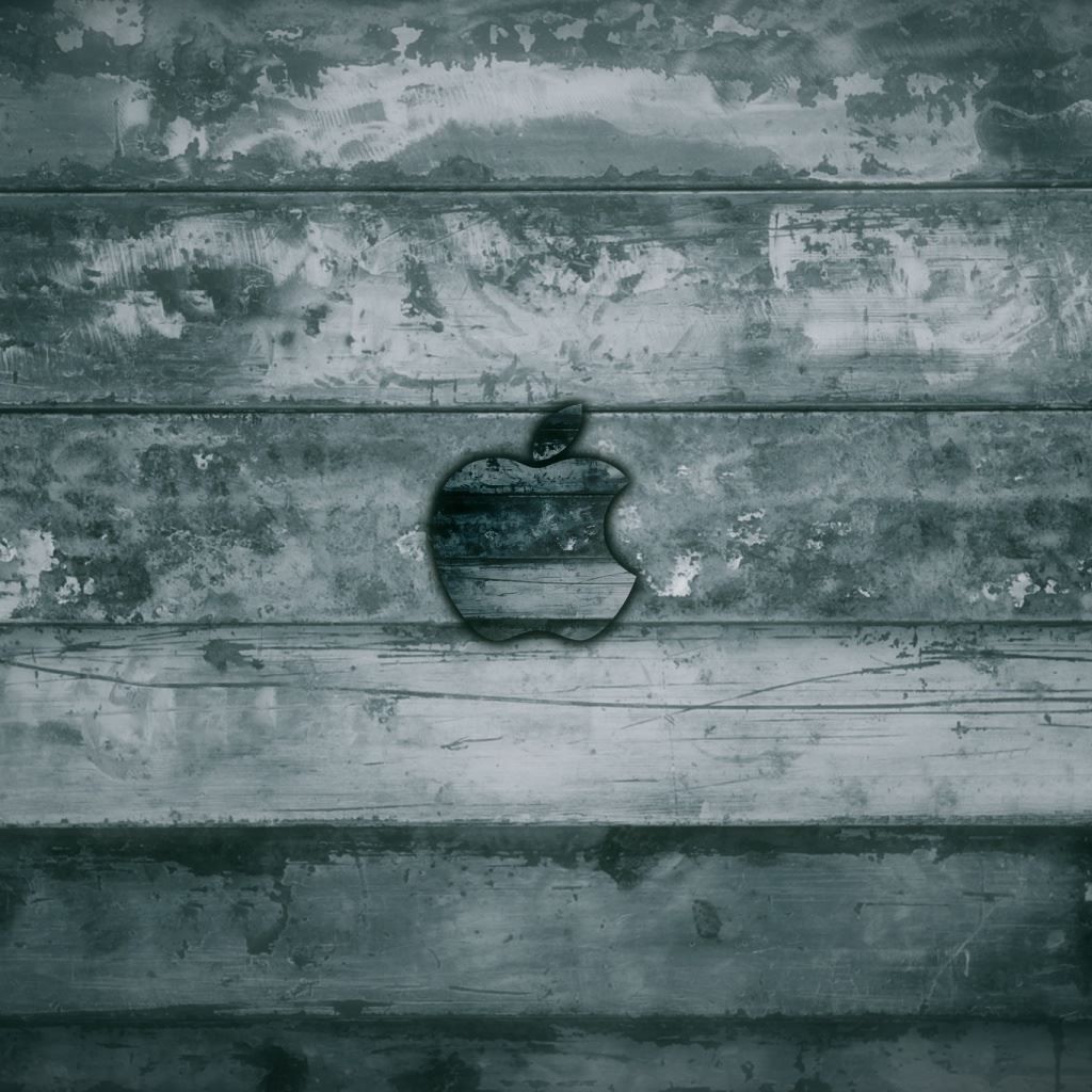 A black and white photo of an apple logo on a wooden wall - Grunge