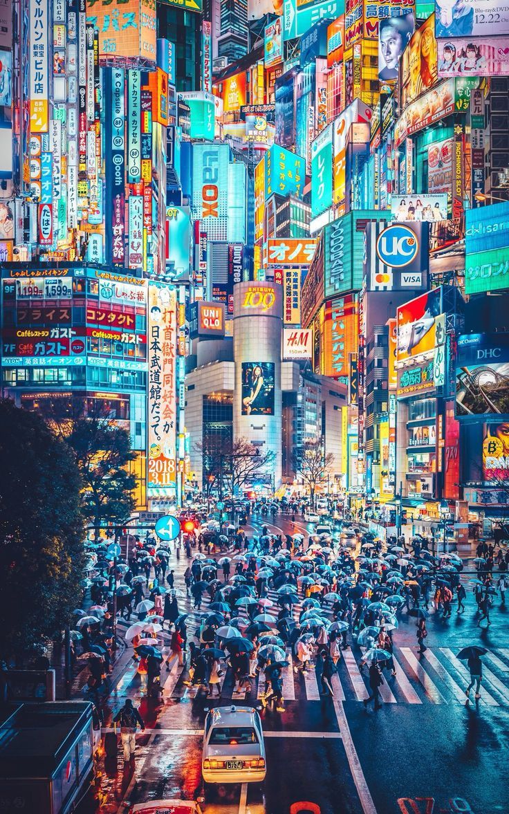 A busy city street at night with many people and neon signs - Japan, Japanese