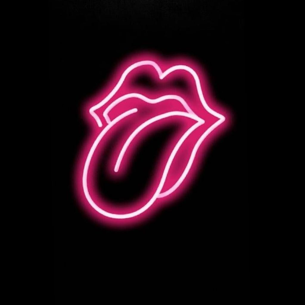 A neon sign of a mouth with the tongue out. - Neon pink