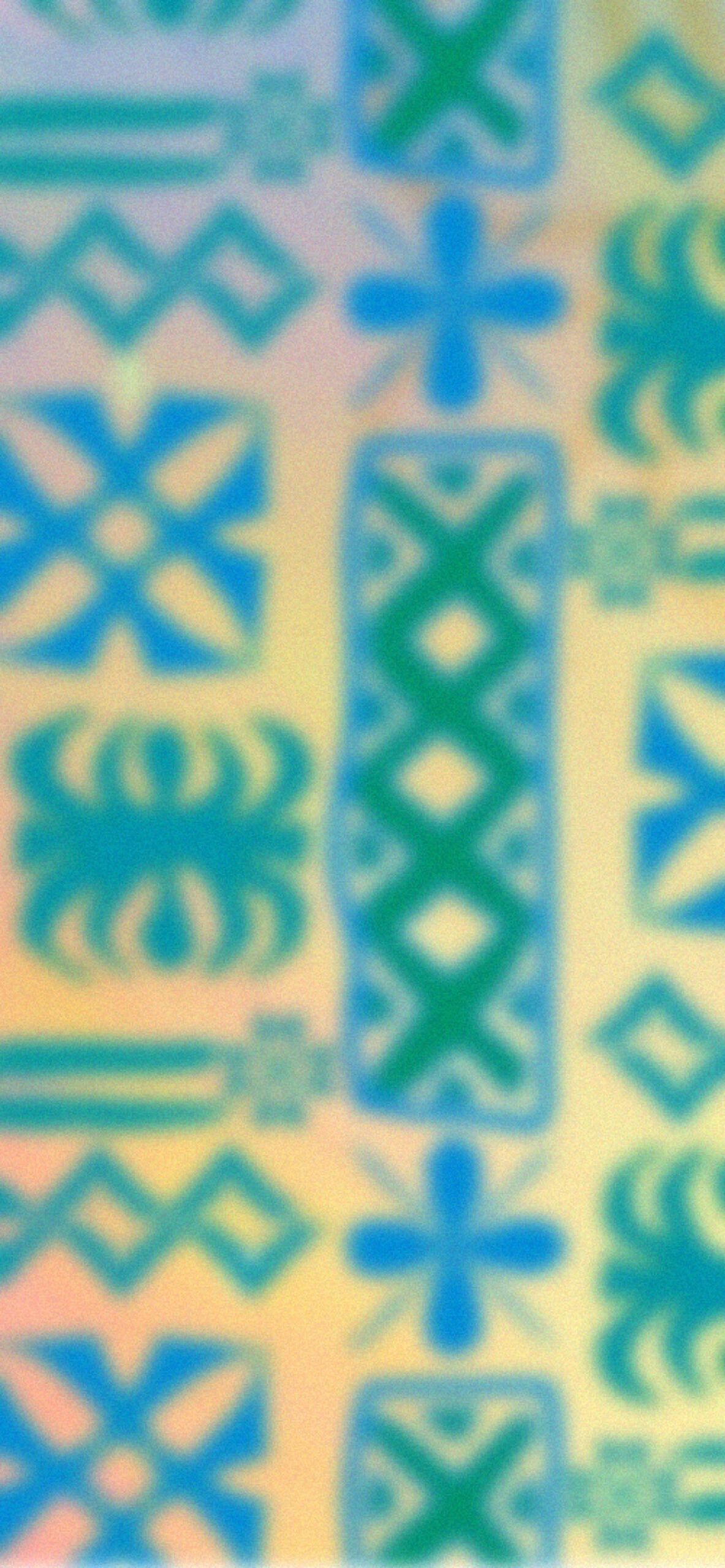 A blurry image of crosses on a yellow and blue background. - SpongeBob