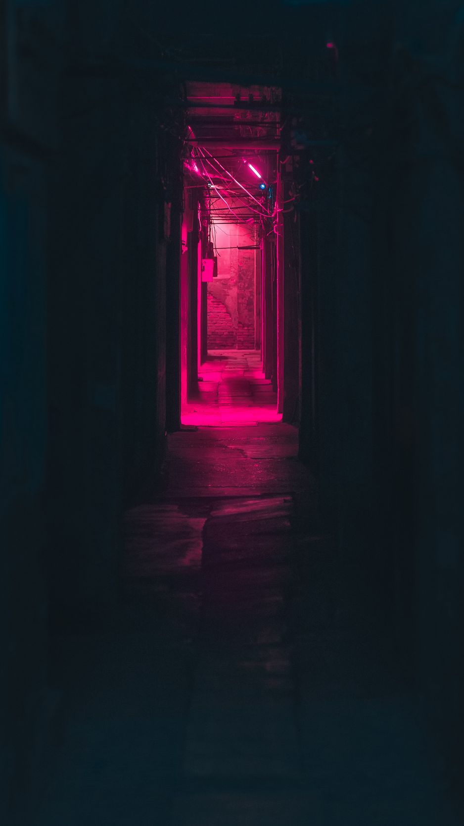 A dark alley with pink lighting - Neon pink