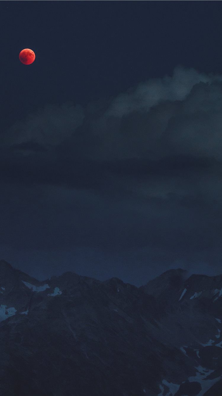 IPhone wallpaper of a red moon over a dark mountain range - Blood