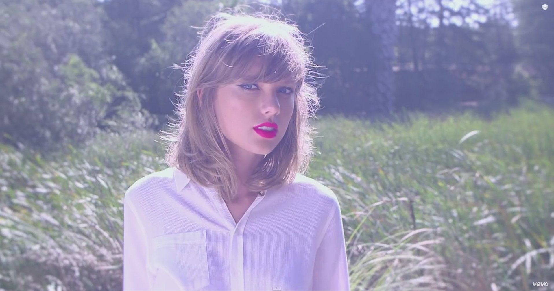 A woman in white shirt and red lipstick - Taylor Swift