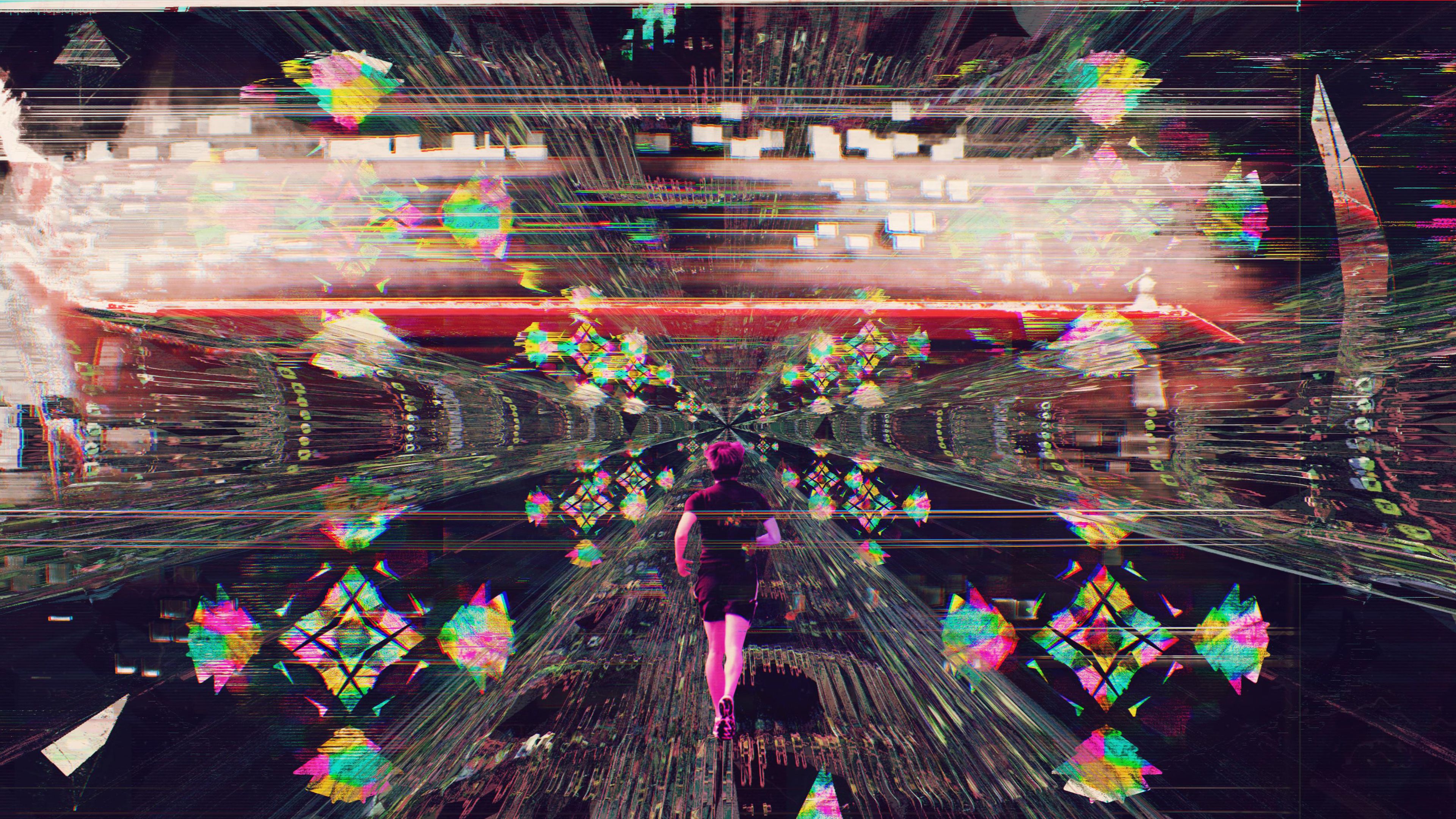 A woman standing in a room with the walls and ceiling covered in colorful projections. - Glitch