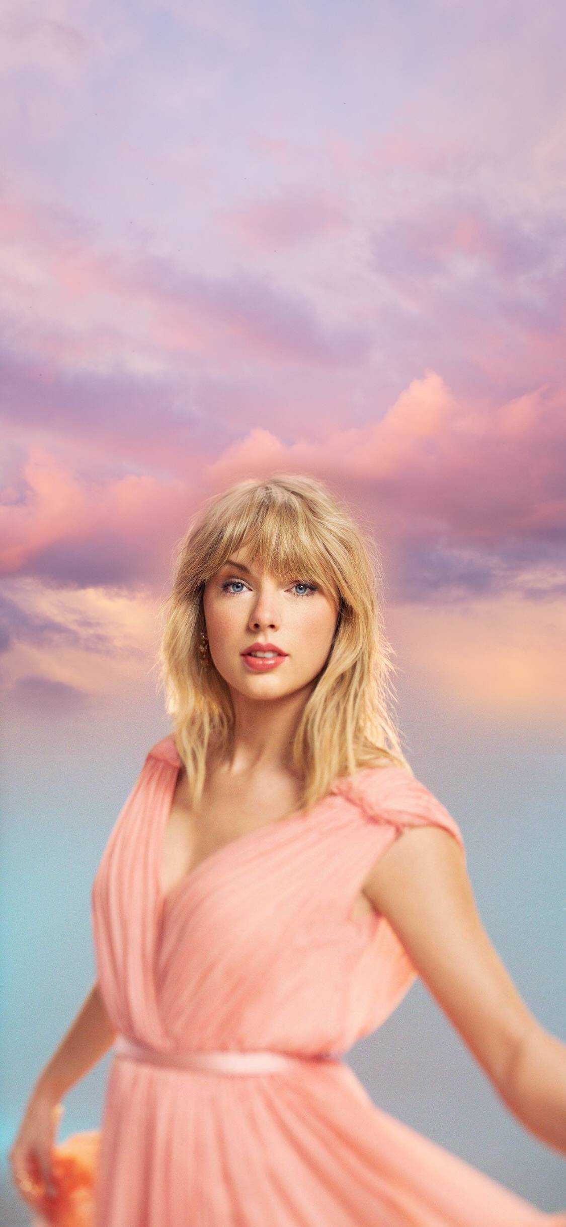 Taylor Swift in a pink dress with a sky background - Taylor Swift